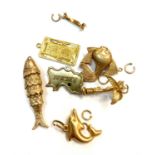 A Chinese high purity gold charm 2.2gm and five other gold charms tog with gold rings 14.2gm