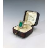 An impressive emerald ring of approximately 2 carats the emerald cut stone set within a band of