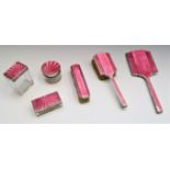 A six piece silver and pink enamel dressing table set.