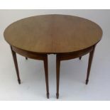 A George III mahogany D end dining table, with two extra leaves, with square tapering legs on