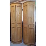 A pair of Continental pine bow front standing corner cupboards, late 19th century, height 251cm,