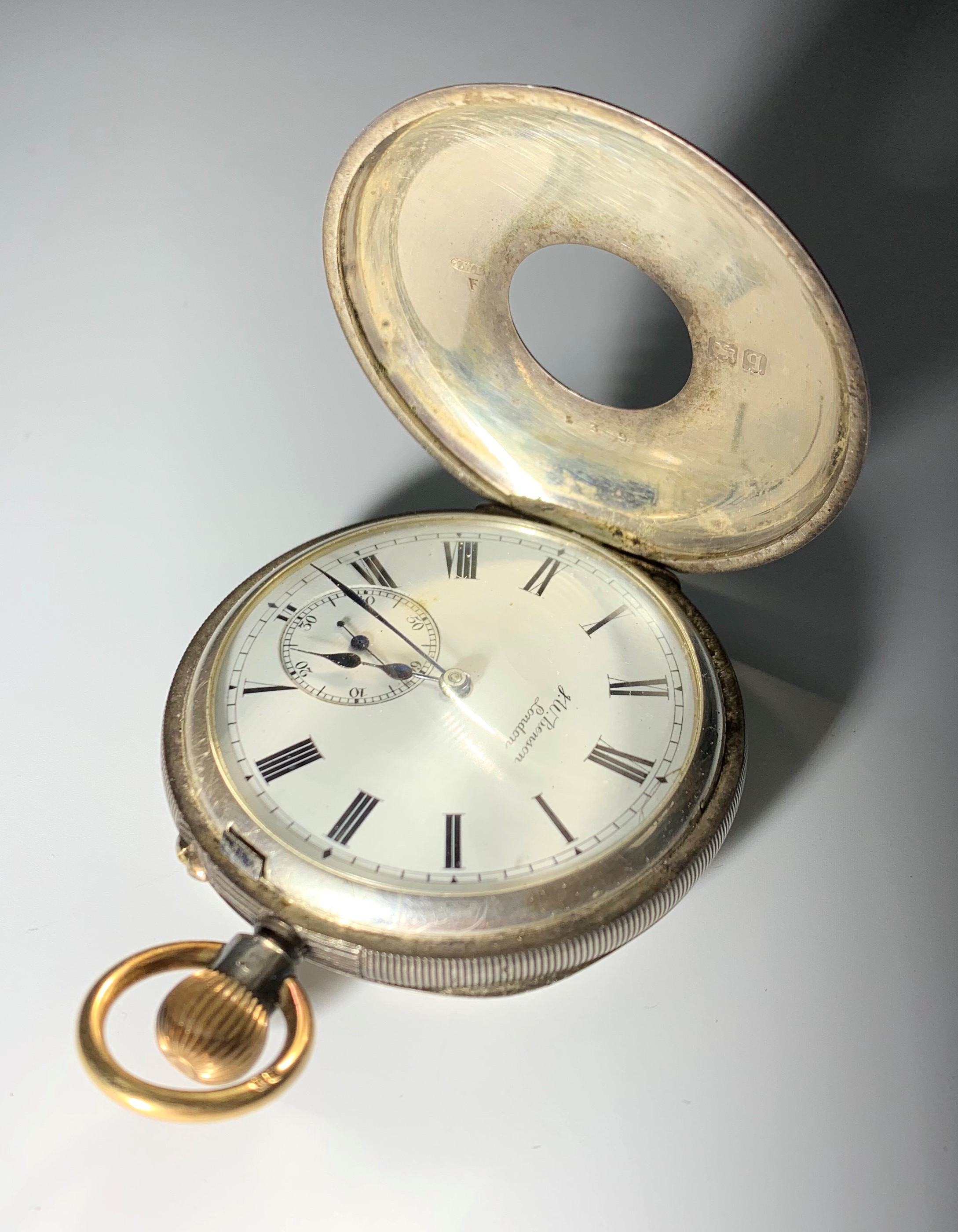 A gold and silver keyless pocket watch by Benson, 'The Field', in engine turned half hunter case