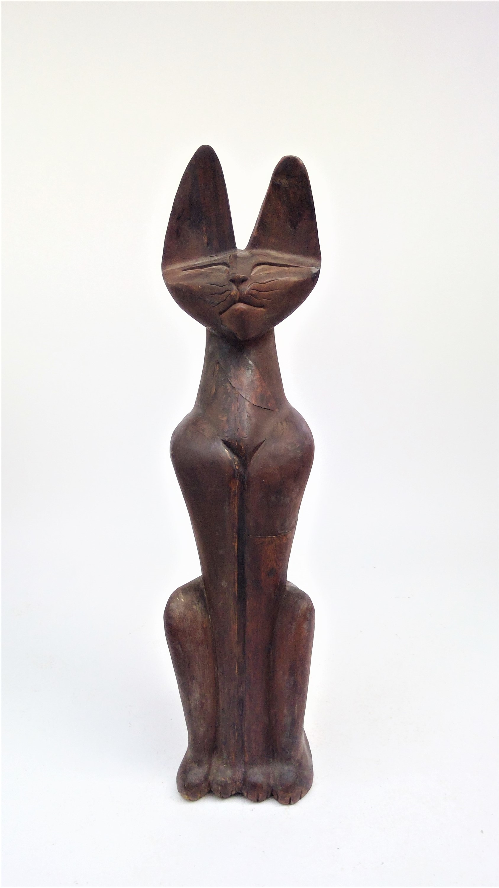 A large carved wood sculpture of a seated cat. Provenance: Purchased by the vendor in Egypt during