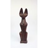 A large carved wood sculpture of a seated cat. Provenance: Purchased by the vendor in Egypt during