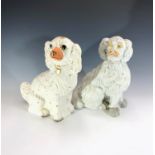 A large Victorian Staffordshire spaniel with curly coat, height 30cm, together with one other
