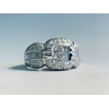 An 18 white gold diamond set ring in 1950's style calibre and pave set with numerous stones.