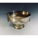 A silver plate on copper punch bowl, with chased floral garland decoration and lion mask ring