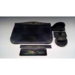 An Art Deco style black lacquered desk set, comprising inkwell, blotter, pen tray, ruler, letter
