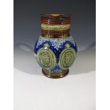 A late 19th century Doulton Lambeth stoneware jug commemorating Queen Victoria's Diamond Jubilee,