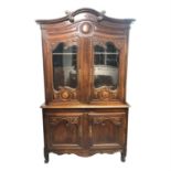 A French carved pine buffet a deux corps, circa 1800, height 226cm, width 135cm.