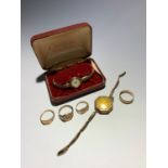 Three 9ct gold signet rings a 9ct gold band 14.6gm and two ladies gold cased watches. Please