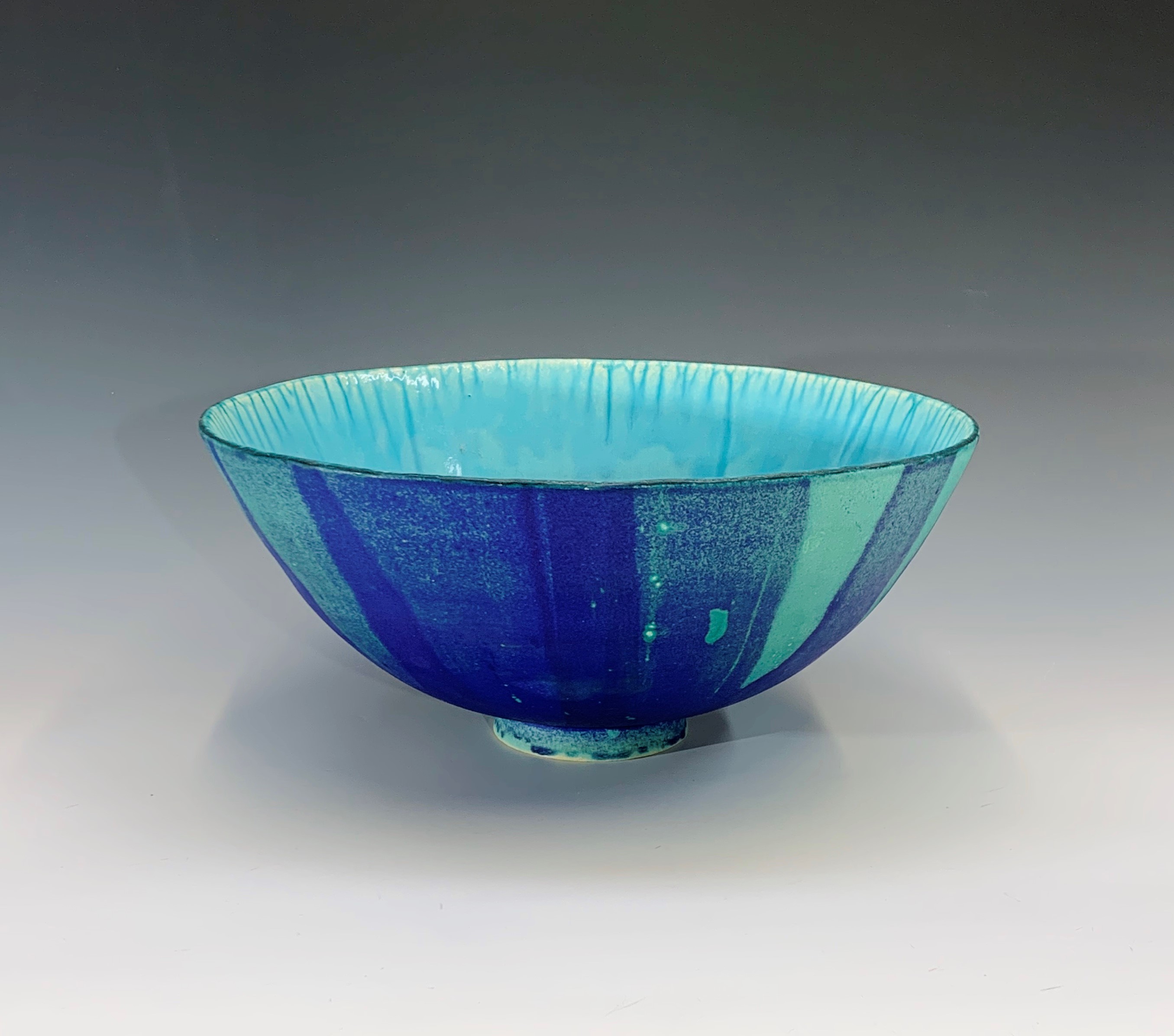 A large stoneware bowl with lapis blue and turquoise glaze. Height 15.5cm, diameter 34cm.Condition