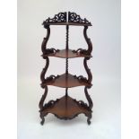 A Victorian rosewood corner whatnot.