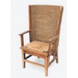 A pine Orkney chair, circa 1900, with woven straw back and open arms above a drop in seat on