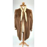 A Catherine Georgiou ladies blonde mink swing jacket, with natural white mink trim to cuffs and