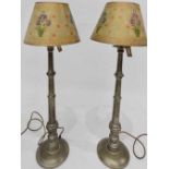 A pair of silver coloured metal table lamps, with Persian design lampshades decorated with irises.