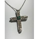 An 18ct white gold metamorphic necklace set with diamonds and emeralds. It's pendant cross hinges