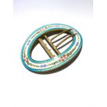 A large gilt and enamel oval buckle.