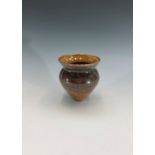 A studio pottery vase of conical form, incised with waterfront houses and boats to the foreground,