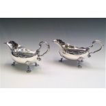 A pair of handsome silver sauce boats with gadrooned borders and shell feet in George II style