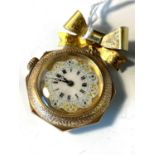 A gold fob watch hanging from a bow broochCondition report: Case 14ct Dust cover not gold Hair