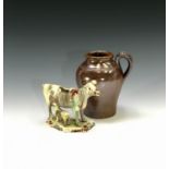 A creamware cow creamer, circa 1770, painted with manganese, height 11cm, together with a late