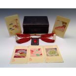 A jewellery box, with contents of coral necklace and five kimono fabric fragments mounted on rice