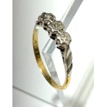 A three stone diamond ring set in 18ct. gold and platinum