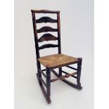 A Lancashire elm and ash ladderback rocking chair, 19th century.