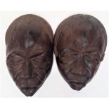 A pair of large figured hardwood tribal masks, with well detailed facial detail. Height 58cm.