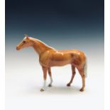 A large Beswick model of a horse - palomino hunter . Height 28.5cm.