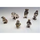 Three Magrino enamelled silver clown models two other silver clown models and a silver dog,