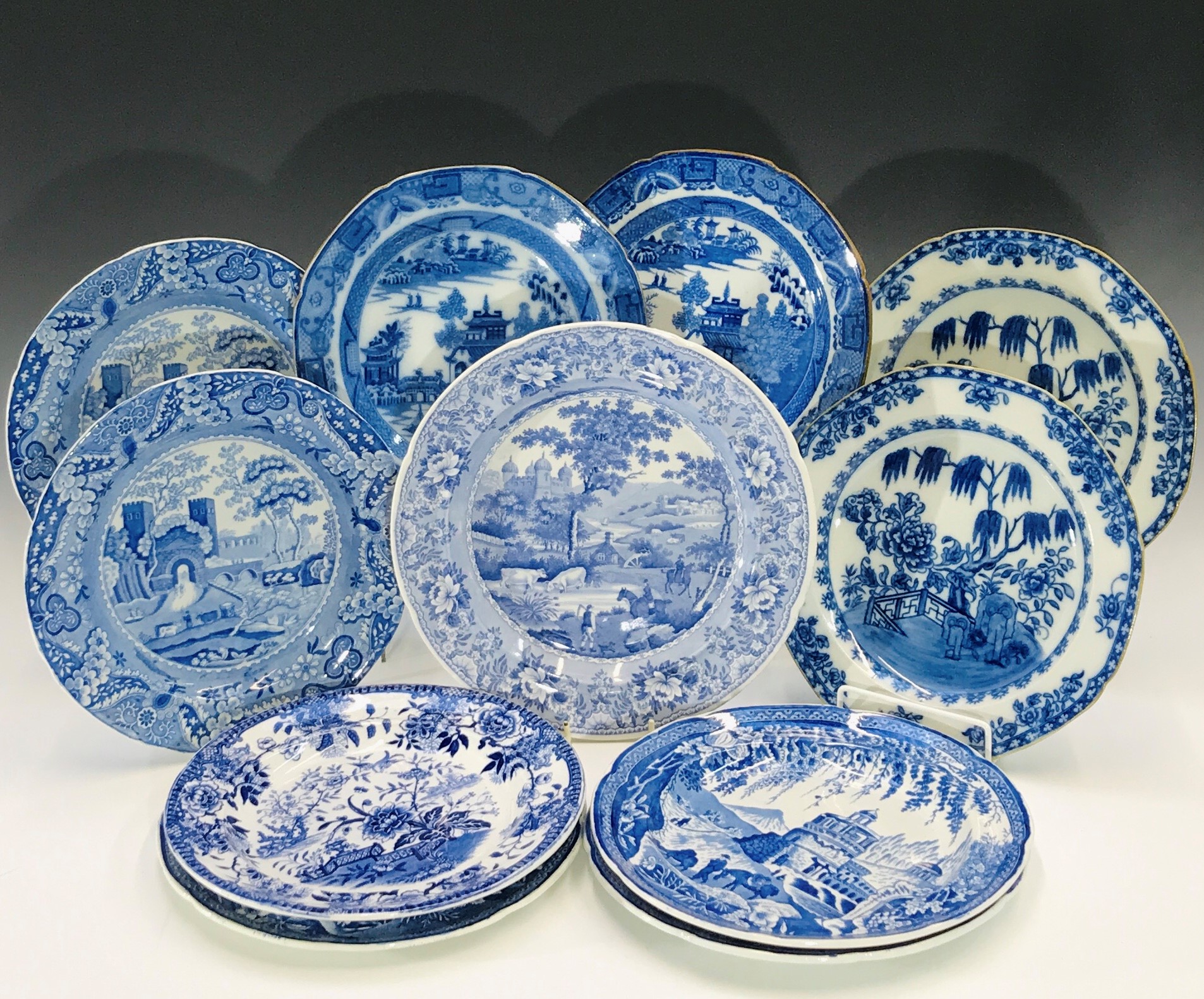 Eleven Cambrian pottery dinner plates, various blue printed patterns and marks.Condition report: One