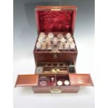 A 19th century mahogany and brass mounted apothecary's box, the red velvet lined lid enclosing 15