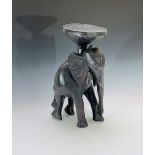 An African carved hardwood tribal stool, in the form of an elephant, height 45.5cm.