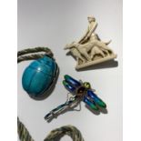 An enamelled silver dragonfly brooch, a scarab pendant and a plastic brooch in the form of a lady
