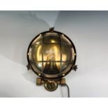A mid 20th century ship's brass circular bulk head lamp. Diameter 26cm.