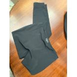 A pair of plain black Gucci leggings with ankle zips, labelled size 44.