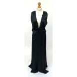 A black sleeveless deconstructed floor length evening dress by Martin Margiela, trademark white