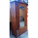 An Edwardian mahogany wardrobe, with single mirrored door above a long drawer, height 209cm, width