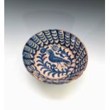 A Spanish majolica bowl painted with a bird and flowering branches. Diameter 26cm.