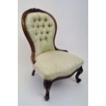 A Victorian walnut lady's salon chair, with buttoned upholstered back and padded seat, on cabriole