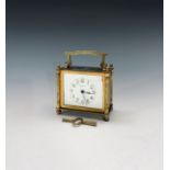 A French brass carriage clock of squat form, the rectangular white enamel dial signed Russells Ltd