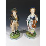 A pair of Victorian porcelain figures of musicians, signed R.J. Morris (Roland James Morris, 1847-