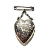 A silver heart shaped vesta case hanging from a silver chain with silver brooch pin. In almost new