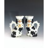 A pair of Victorian Staffordshire jugs modelled as spaniels. Height 20cm.Condition report: Some