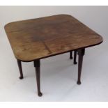A George III mahogany drop leaf dining table, with six circular form tapering legs with pad feet,
