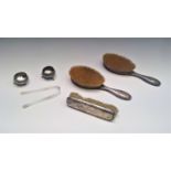 Three silver mounted brushes, a William Comyns sweetmeat dish, etc.