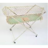 A folding wrought iron framed cot.