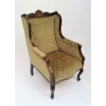 An Edwardian inlaid walnut armchair, with cabriole front legs.